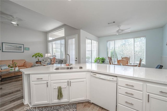 kitchen featuring light hardwood / wood-style floors, dishwasher, white cabinetry, sink, and ceiling fan