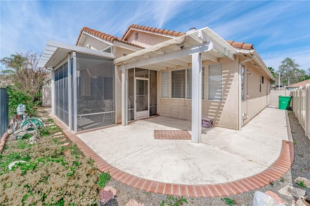 back of house featuring a patio area, a sunroom, and a pergola