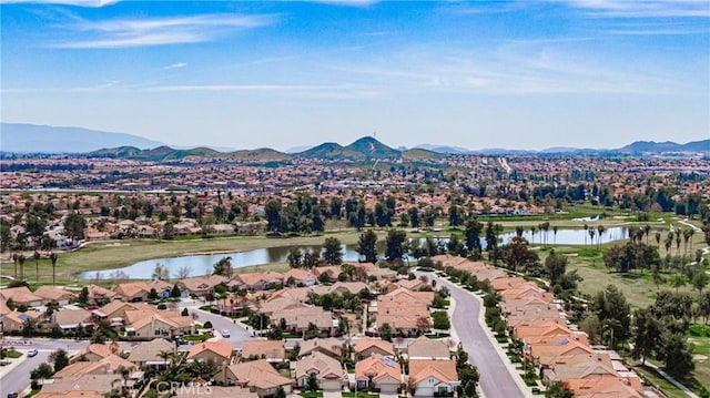 birds eye view of property with a water and mountain view