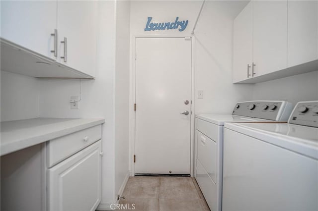 laundry area featuring cabinets and washing machine and dryer