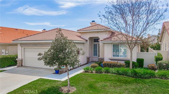 mediterranean / spanish-style house with a garage and a front yard