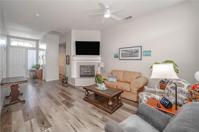 living room featuring ceiling fan and light hardwood / wood-style flooring