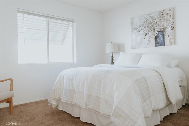 bedroom featuring carpet and baseboards