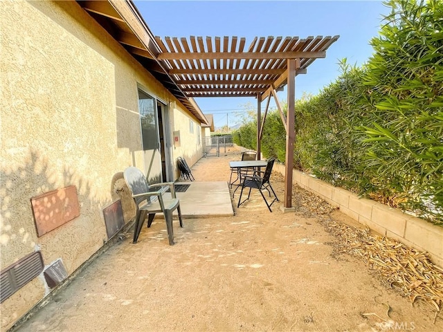 view of patio featuring a pergola and fence