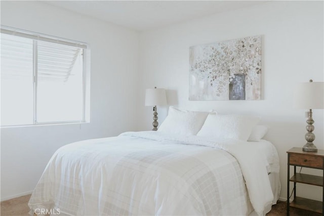 bedroom featuring baseboards and carpet floors