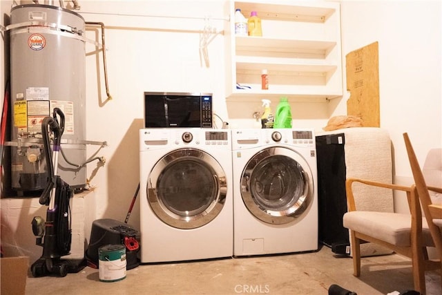 clothes washing area featuring gas water heater and washing machine and dryer