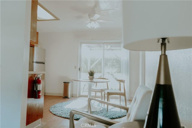 living area with ceiling fan and hardwood / wood-style floors