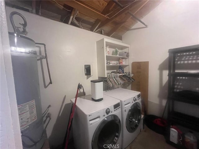 clothes washing area featuring gas water heater, independent washer and dryer, and laundry area