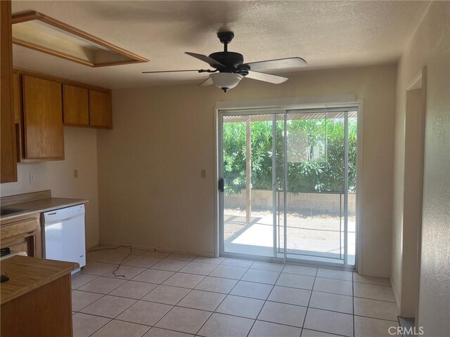 kitchen with ceiling fan, a textured ceiling, dishwasher, and light tile patterned flooring