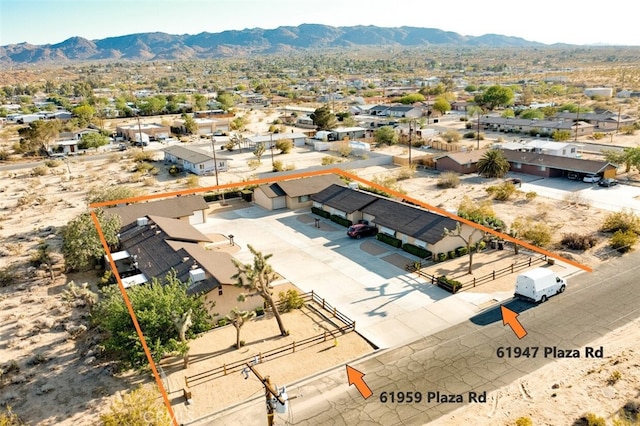 birds eye view of property featuring a mountain view and a residential view