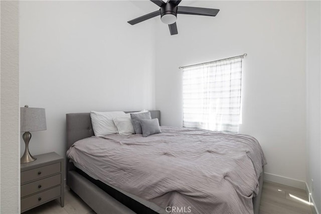 bedroom with light hardwood / wood-style flooring and ceiling fan