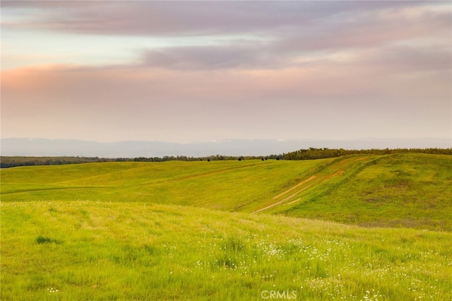 nature at dusk featuring a rural view