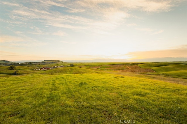 aerial view at dusk featuring a rural view