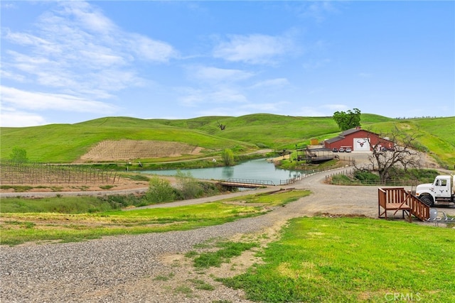 surrounding community featuring a water and mountain view and a rural view