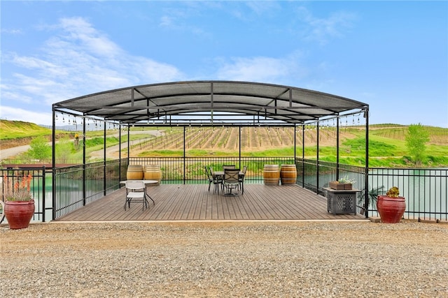 view of patio with a rural view and a deck with water view