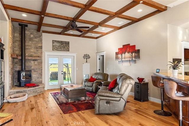 living room featuring beam ceiling, coffered ceiling, light hardwood / wood-style floors, and french doors