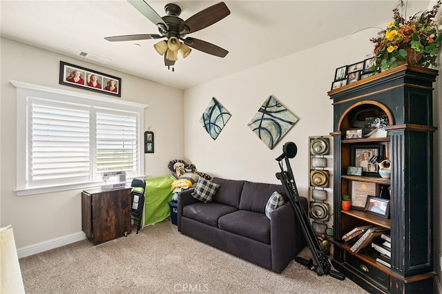 living room with light colored carpet and ceiling fan