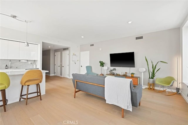 living room with light hardwood / wood-style flooring