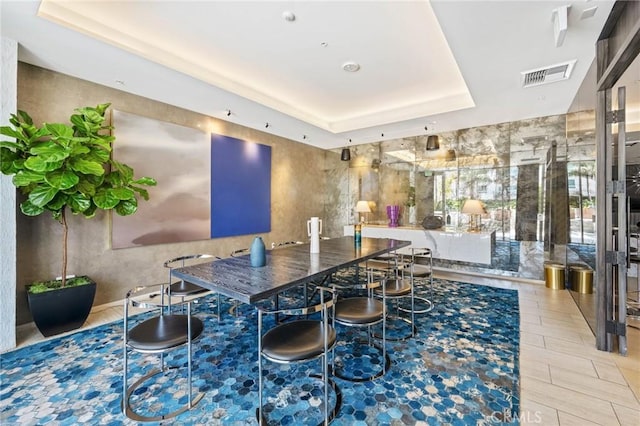 dining room with a tray ceiling