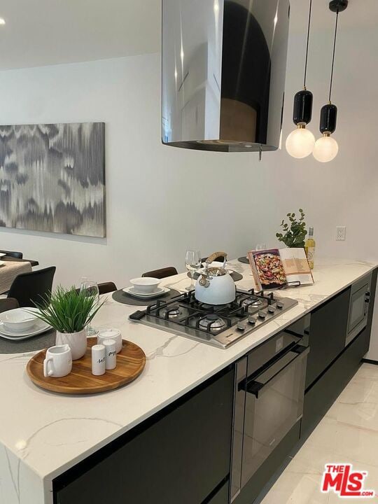 kitchen featuring stainless steel gas stovetop, pendant lighting, oven, and ventilation hood