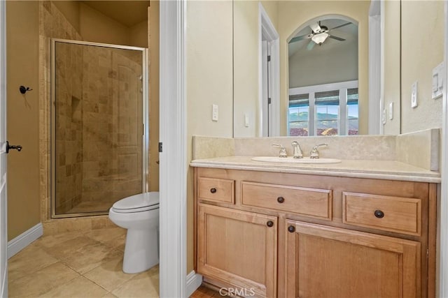 bathroom featuring toilet, ceiling fan, an enclosed shower, and vanity