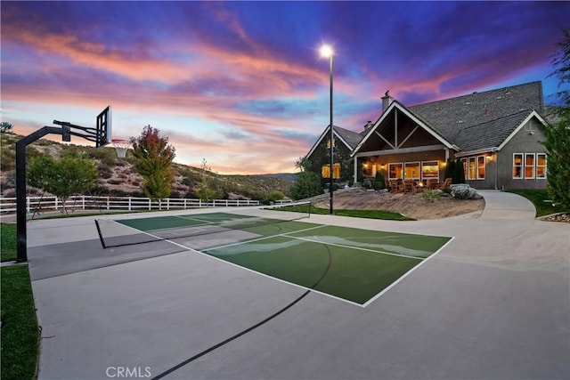 view of basketball court featuring tennis court and a mountain view