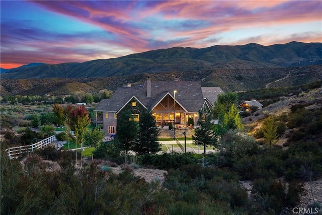 back house at dusk featuring a mountain view