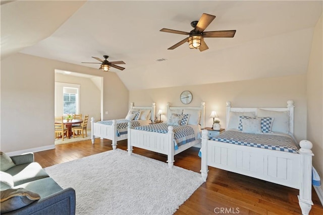 bedroom featuring dark wood-type flooring, ceiling fan, and lofted ceiling