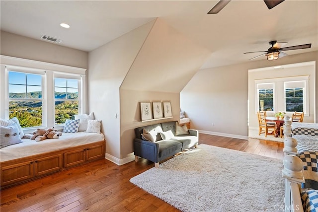 sitting room with vaulted ceiling, ceiling fan, and hardwood / wood-style floors