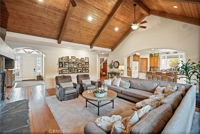 living room with beamed ceiling, wood ceiling, hardwood / wood-style flooring, and high vaulted ceiling