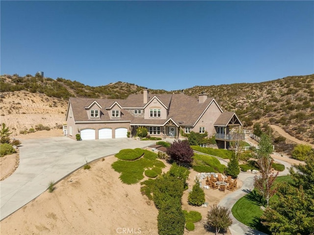 view of front of home featuring a garage and a mountain view