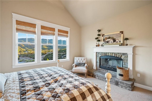 carpeted bedroom featuring lofted ceiling, a fireplace, and multiple windows