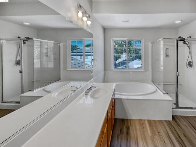 bathroom featuring vanity, separate shower and tub, and hardwood / wood-style floors