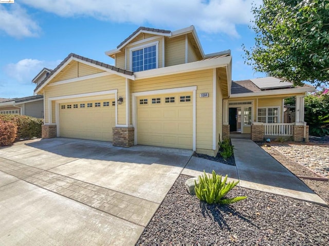 craftsman inspired home featuring covered porch and a garage