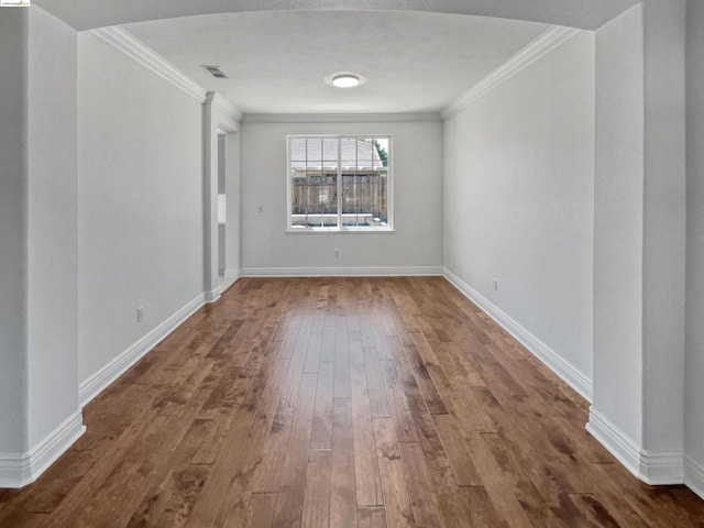 unfurnished room with ornamental molding and hardwood / wood-style flooring