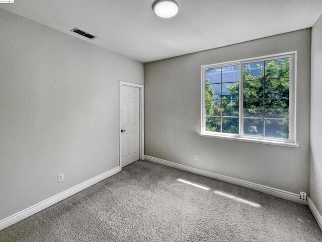 carpeted empty room featuring a healthy amount of sunlight