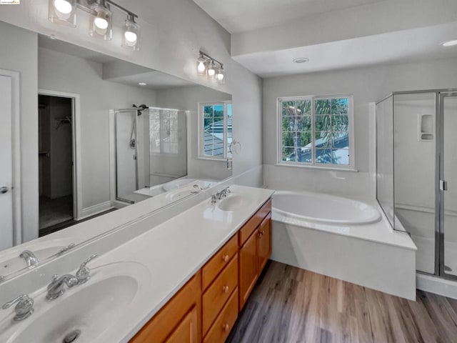 bathroom featuring vanity, hardwood / wood-style flooring, and shower with separate bathtub