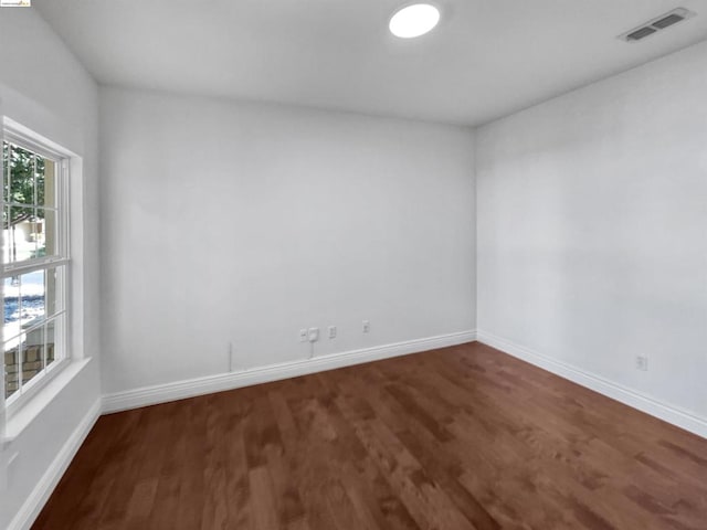 empty room with dark wood-type flooring