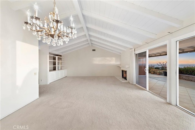 unfurnished living room featuring lofted ceiling with beams, carpet, and an inviting chandelier