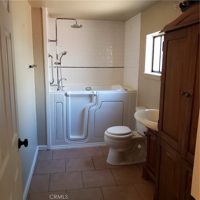 full bathroom featuring tiled shower / bath, tile patterned floors, vanity, and toilet