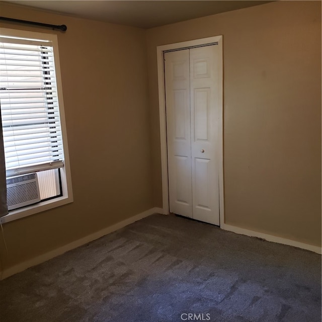 unfurnished bedroom featuring a closet and carpet flooring