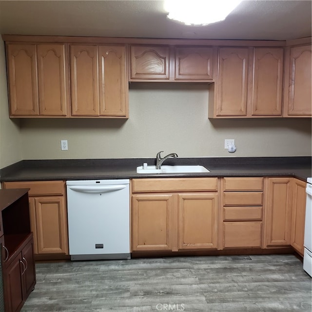 kitchen featuring white appliances, sink, and light hardwood / wood-style floors