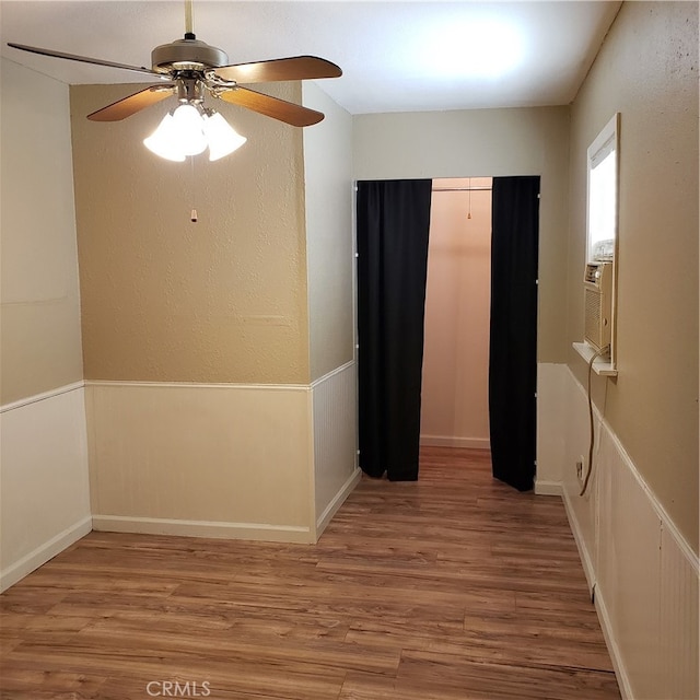 corridor with hardwood / wood-style flooring