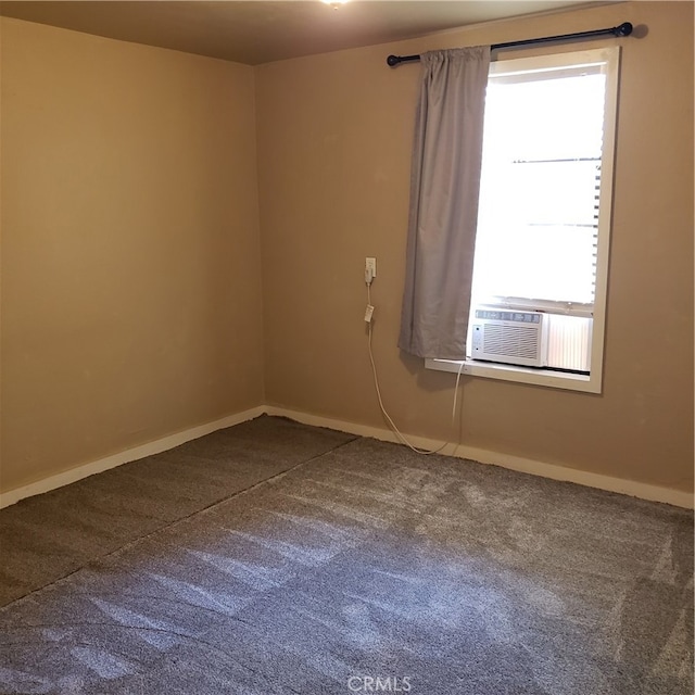 carpeted spare room featuring cooling unit