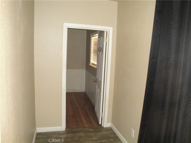 corridor with dark wood-type flooring