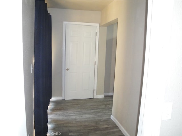 corridor featuring dark hardwood / wood-style floors