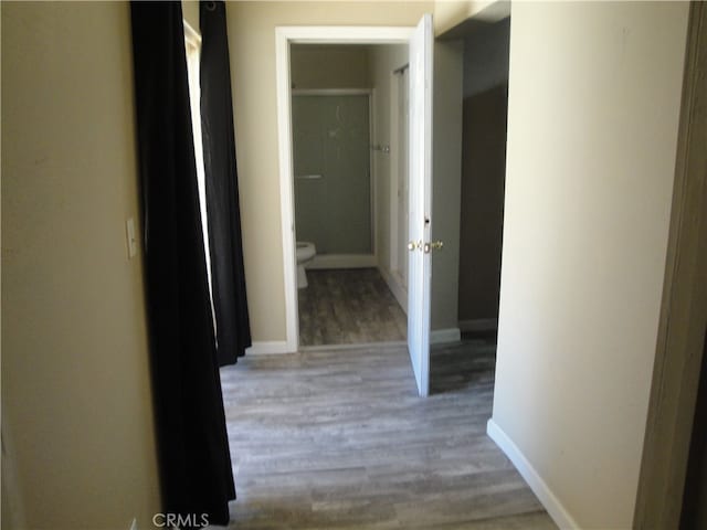 hallway with hardwood / wood-style flooring