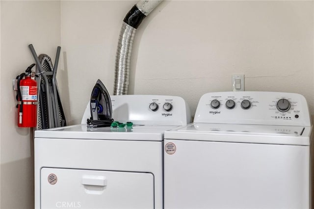 clothes washing area featuring independent washer and dryer