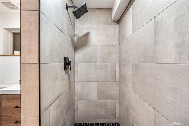 bathroom with tiled shower