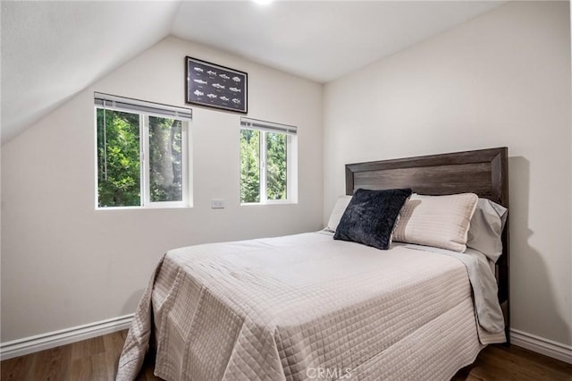 bedroom featuring wood-type flooring and vaulted ceiling